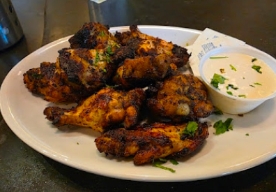 Pies & Pints signature dishes Chicken Gouda Pie
Char-Grilled Hot Wings
Greek Salad